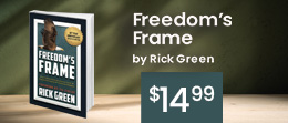 Freedom's Frame book on a table with a green blurred background
