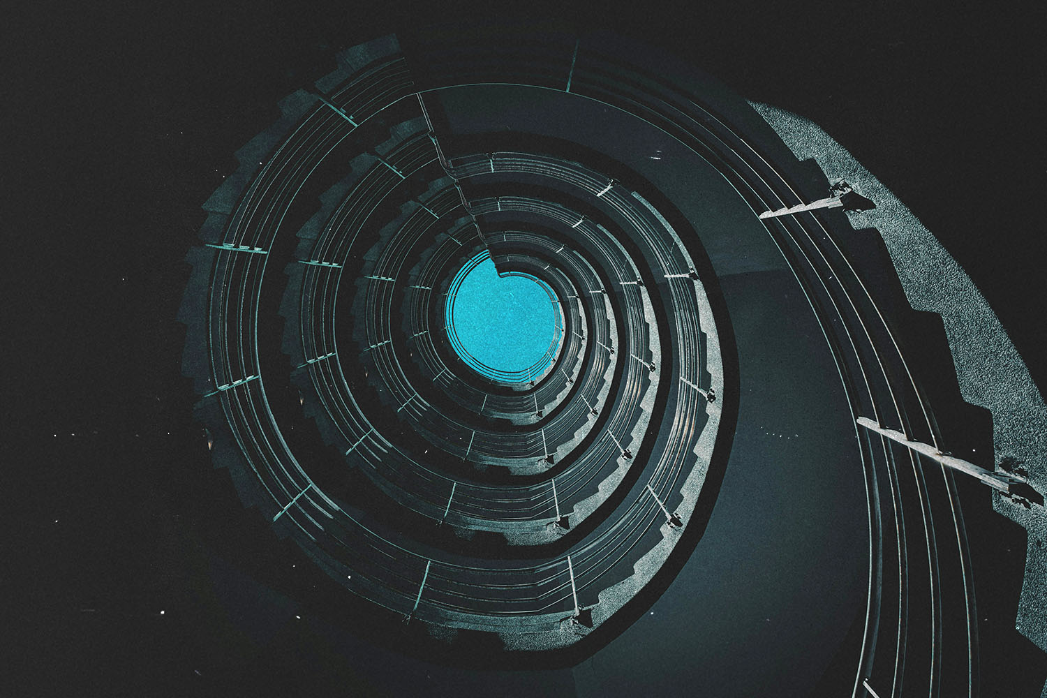 Circular view looking upward through a spiraling architectural structure toward a bright blue opening