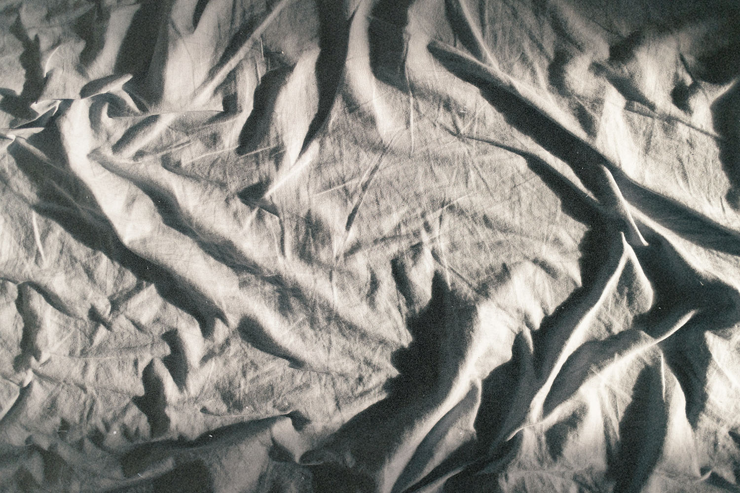 Close-up of rumpled fabric with deep folds and shadows