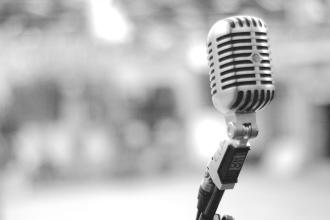 Vintage-style microphone on a stand with a blurred background