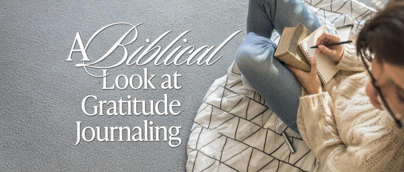 Woman writing in a notebook at a cozy desk, practicing gratitude journaling in a peaceful, softly lit room.
