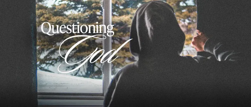 A person in a hoodie looks out a window on a cold day, reflecting on doubt and hope, symbolizing someone you love who may be questioning God in a hard season.